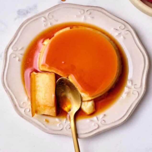 Creamy caramel flan dessert with rich caramel sauce on an elegant white plate, perfect for indulgent desserts and healthy eating.