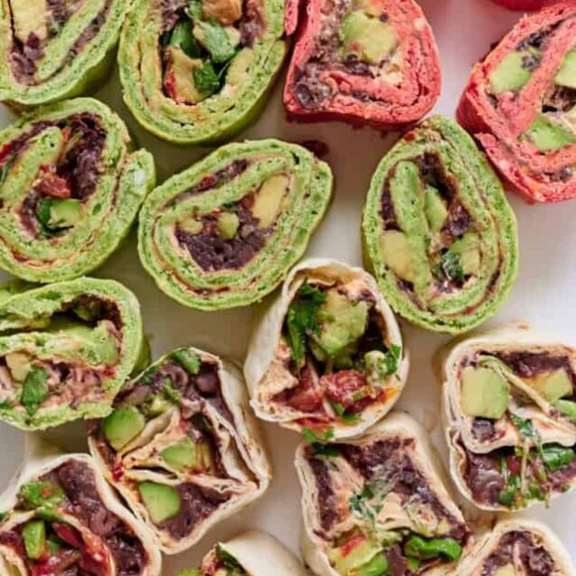Rolled vegetable wrap snacks with colorful spinach, beet, and herb fillings, perfect for healthy bites, meal prep, or nutritious snacking, featuring vibrant, fresh ingredients, and appealing presentation.