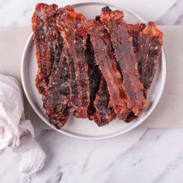 Crispy bacon strips glazed with a rich, savory barbecue sauce, perfect for healthy snacking and meal prep. Ideal for keto and low-carb diets.