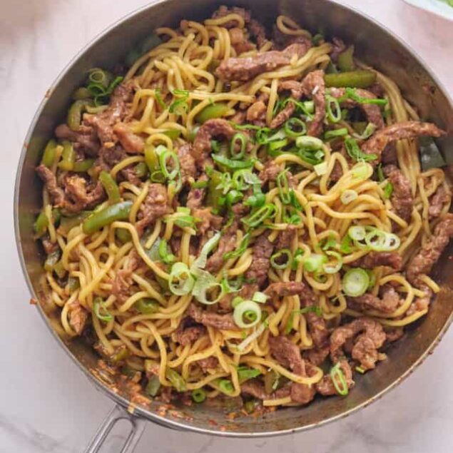 Stir-fried beef and noodle bowl with green onions, a healthy and flavorful Asian-inspired recipe for weight loss and meal prep.