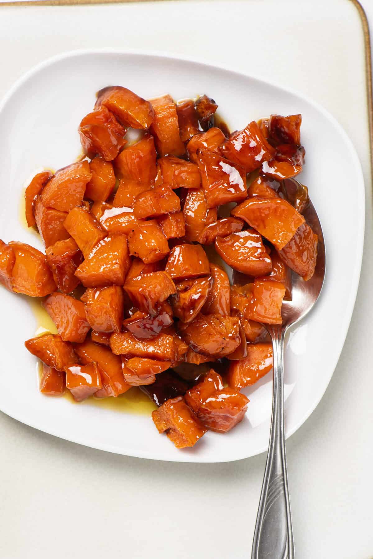 Sweet roasted carrots dish on white plate, healthy vegetable recipe, vegan-friendly food.