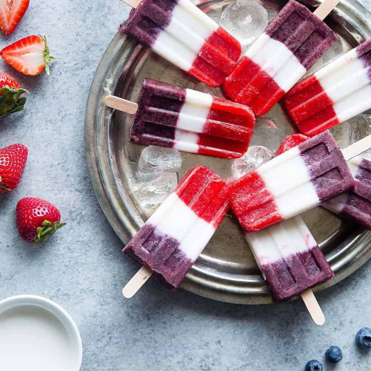 Vegan Red, White and Blue Popsicles - These healthy and dairy free coconut popsicles are a gluten free, patriotic summer treat that are only 4 ingredients and 110 calories! Perfect for July 4th! | Foodfaithfitness.com | @FoodFaithFit