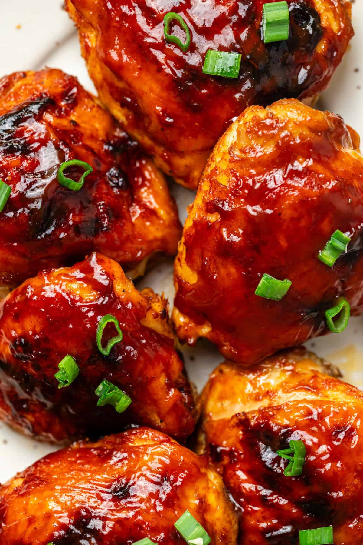 Juicy baked chicken wings coated in barbecue sauce with chopped green onions, perfect for healthy meal options and flavorful recipes.