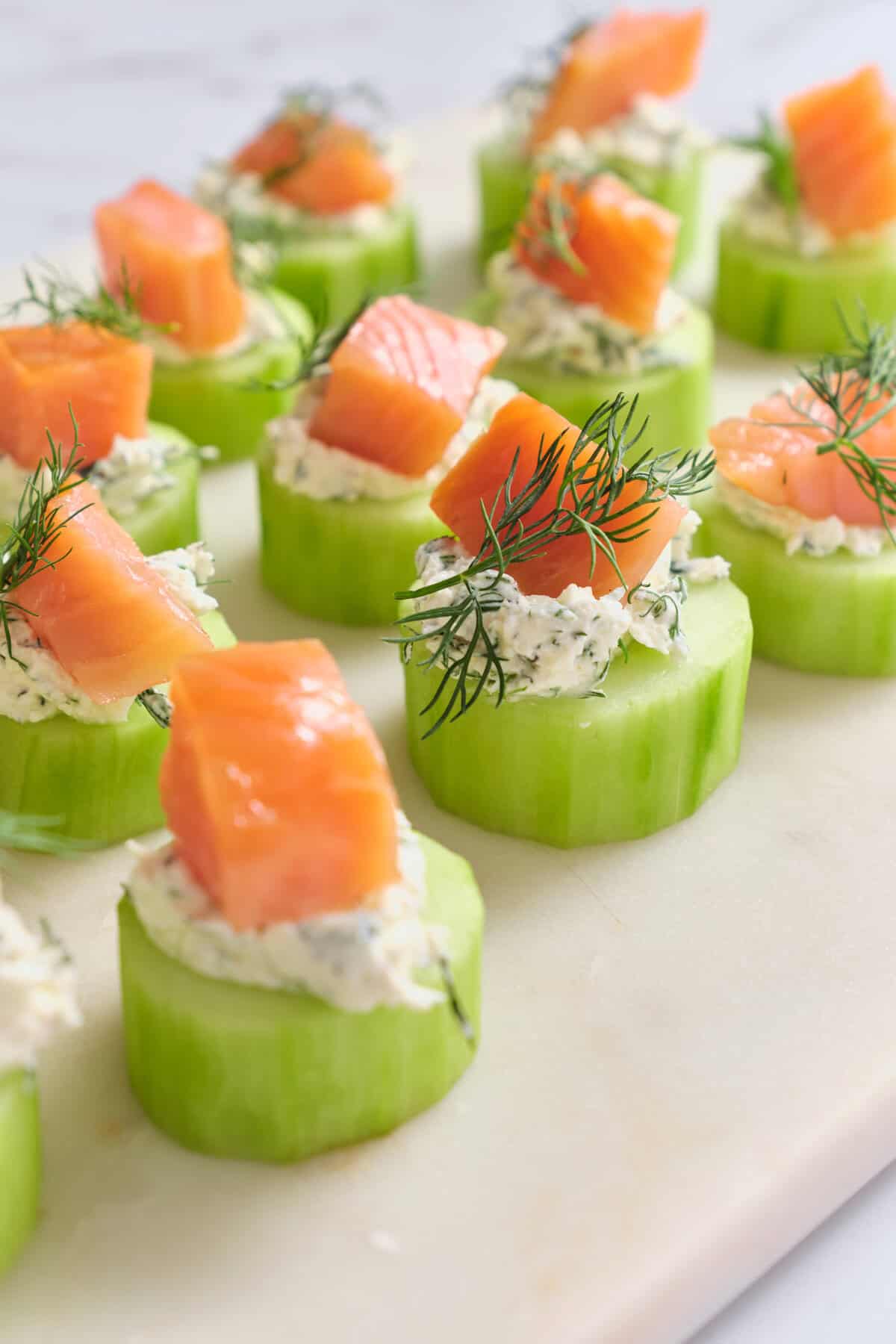 Fresh cucumber bites topped with smoked salmon, cottage cheese, and dill for a healthy, nutritious snack or appetizer. Perfect for balanced eating and fitness-focused meals from Food Faith Fitness.