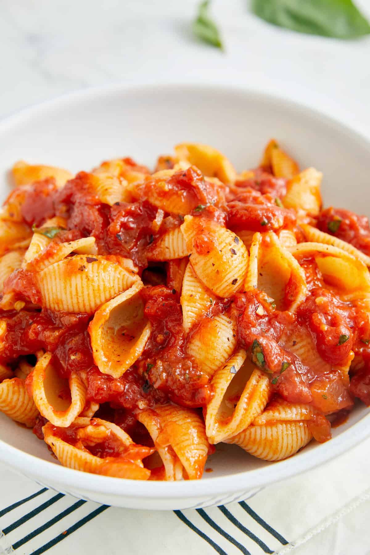 Creamy tomato pasta with shell pasta and fresh herbs, perfect for a healthy, flavorful meal at Food Faith Fitness.