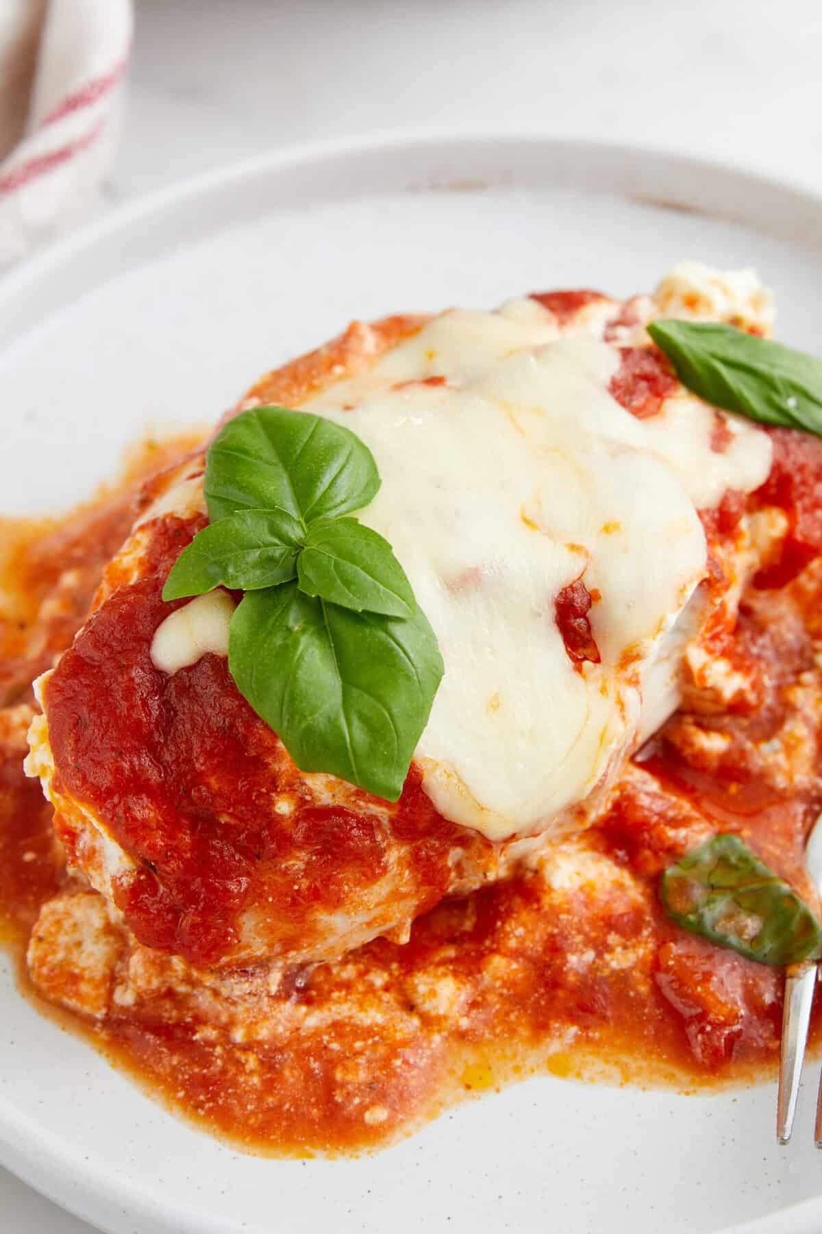 Baked eggplant parmesan with marinara sauce and fresh basil, healthy Italian vegetarian recipe, gluten-free, low-carb dinner idea, Food Faith Fitness.