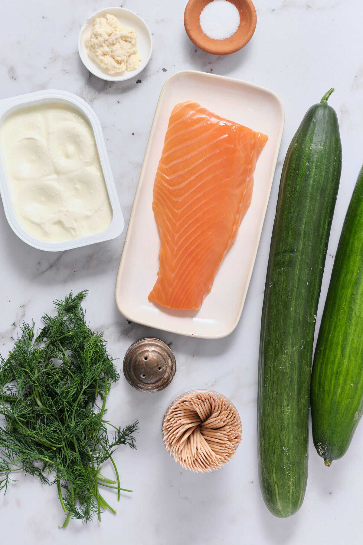 Fresh salmon fillet with zucchini, garlic, parmesan cheese, and herbs for healthy and nutritious meal recipes.