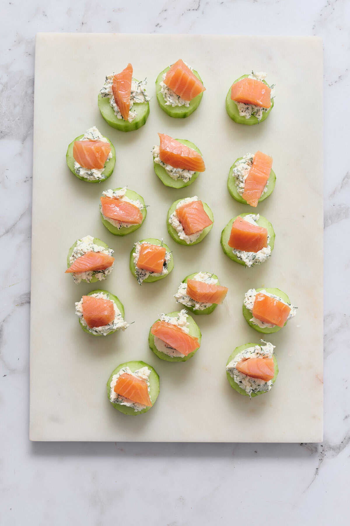 Smoked salmon cucumber bites with cream cheese and herbs, healthy appetizer, keto-friendly, low carb snack, easy party appetizer, gluten-free food, nutritious light bites, Food Faith Fitness recipe.