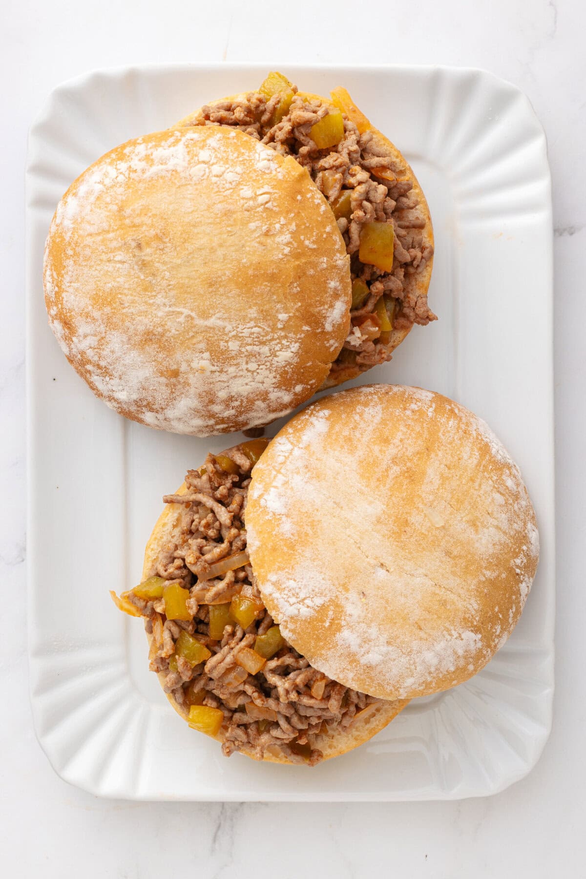 Savory beef and vegetable sandwiches on soft buns, perfect for healthy meal options and quick dinners. Made with ground beef, diced onions, and bell peppers, served on fresh, fluffy bread.