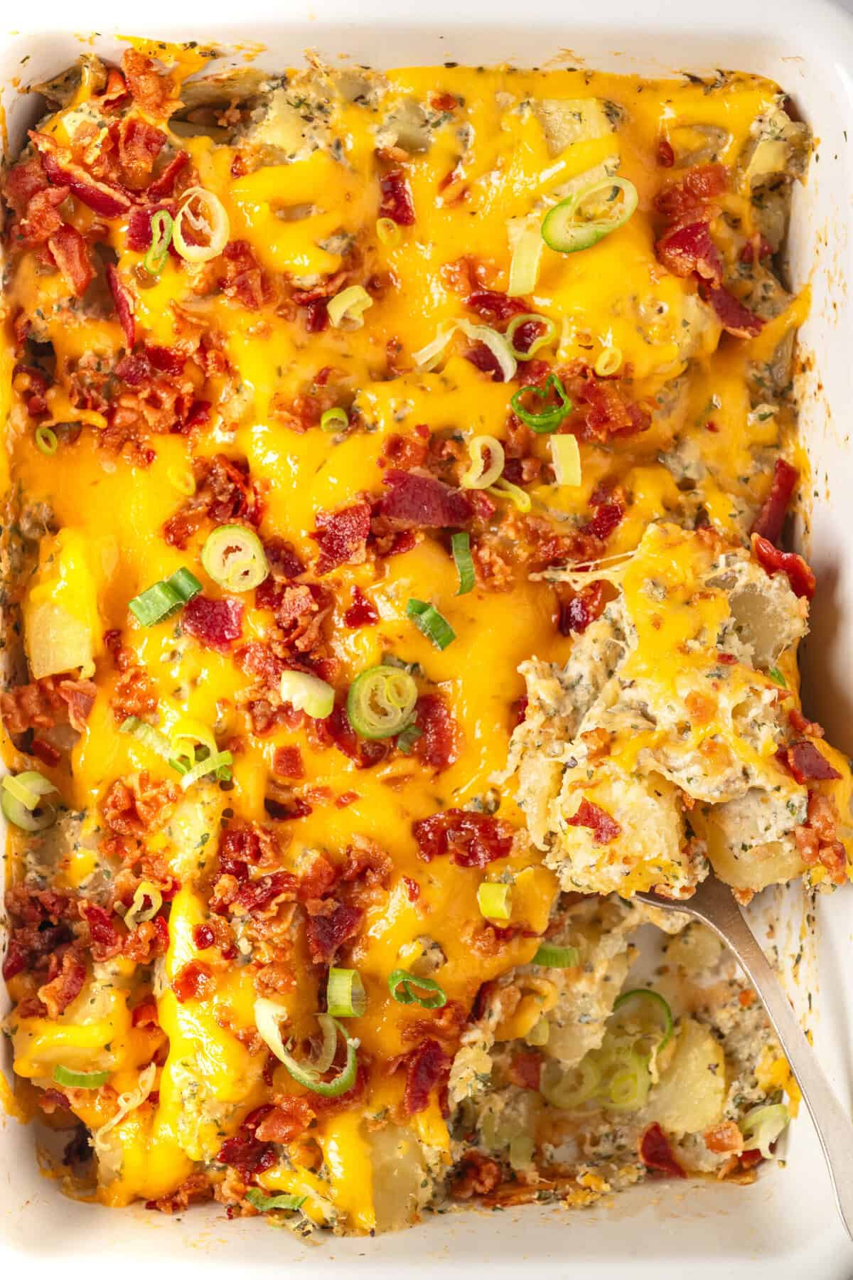 Savory breakfast casserole with eggs, cheese, bacon, and green onions, baked to perfection and topped with melted cheese and crispy bacon bits. A hearty, flavorful meal for brunch or breakfast.