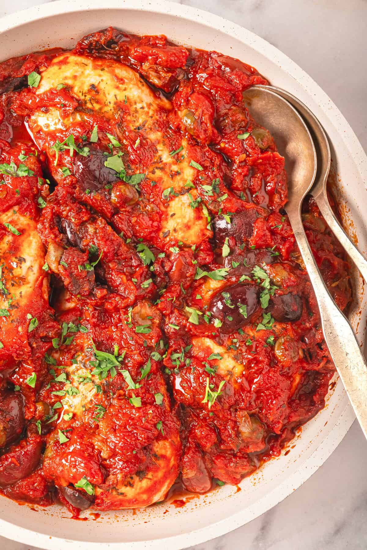 Savory baked chicken thighs in rich tomato sauce with eggplant and herbs, perfect for a healthy, flavorful dinner. Easy baked chicken recipes for a nutritious family meal.
