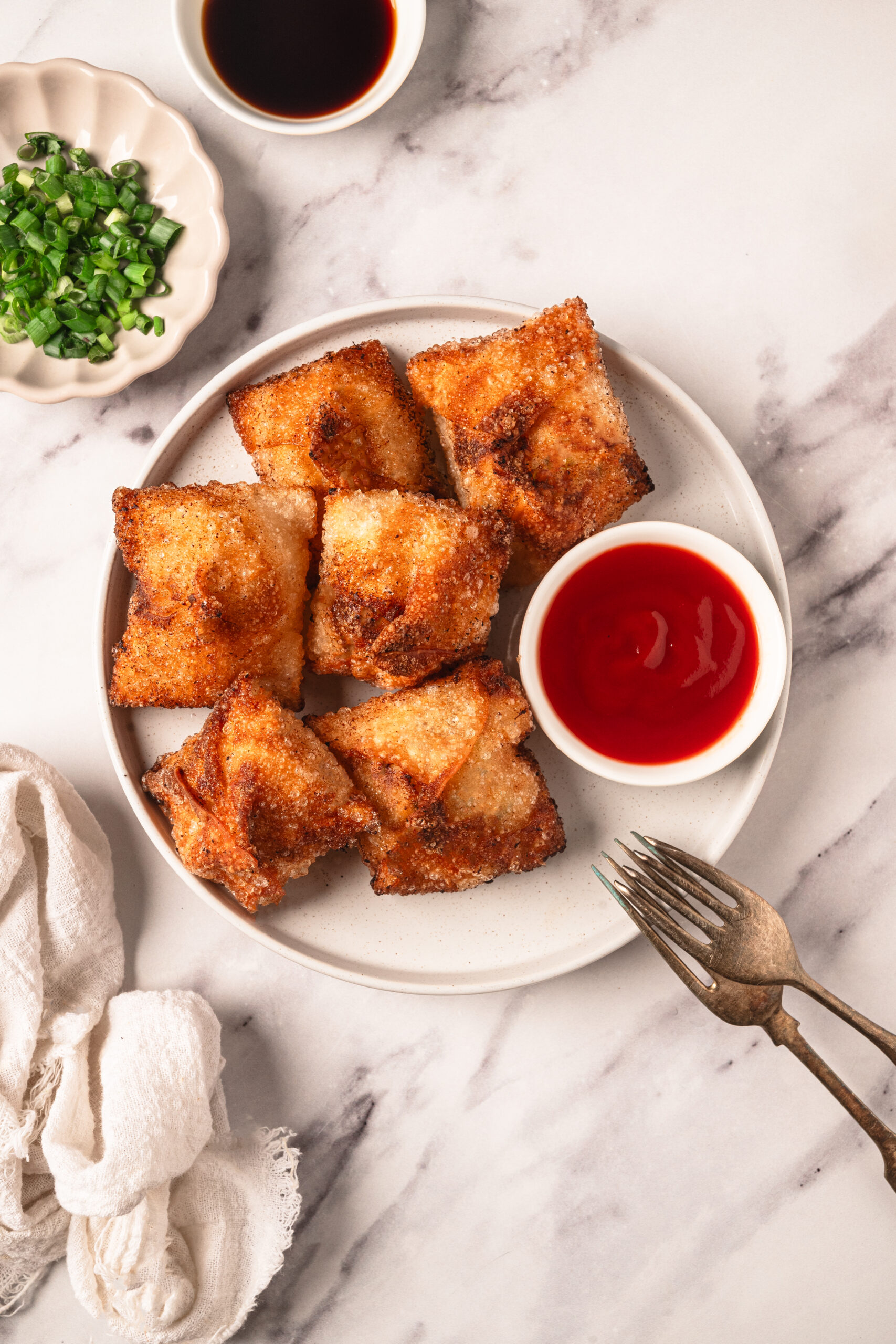 Golden crispy egg rolls served with sweet chili sauce, accompanied by chopped green onions and soy sauce for dipping, perfect for healthy eating and easy meal ideas on Food Faith Fitness.