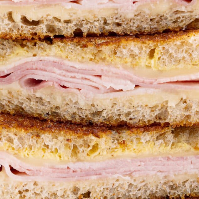 Succulent sandwich with ham and cheese with roasted bread, melted cheese and chopped ham, ideal for fast, healthy food or snack. Made of fresh ingredients for satisfactory taste.