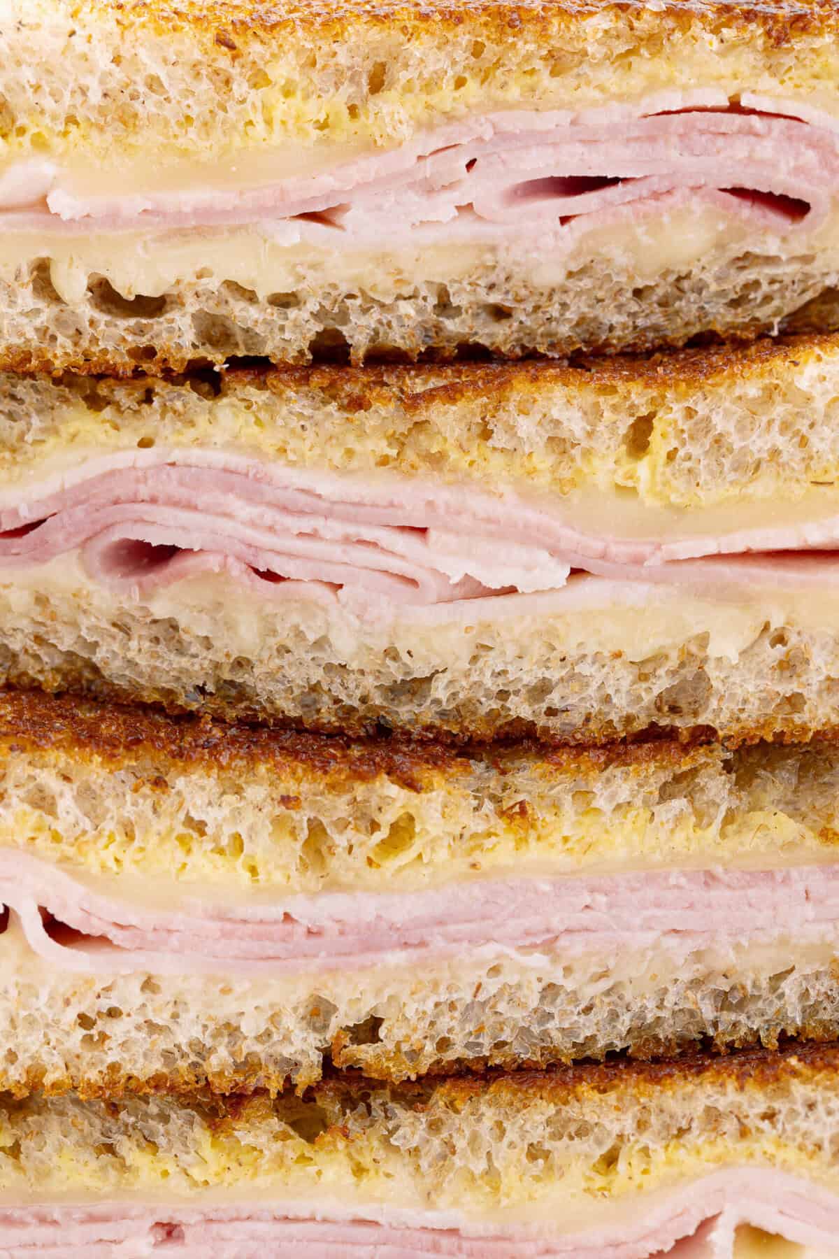 Succulent sandwich with ham and cheese with roasted bread, melted cheese and chopped ham, ideal for fast, healthy food or snack. Made of fresh ingredients for satisfactory taste.