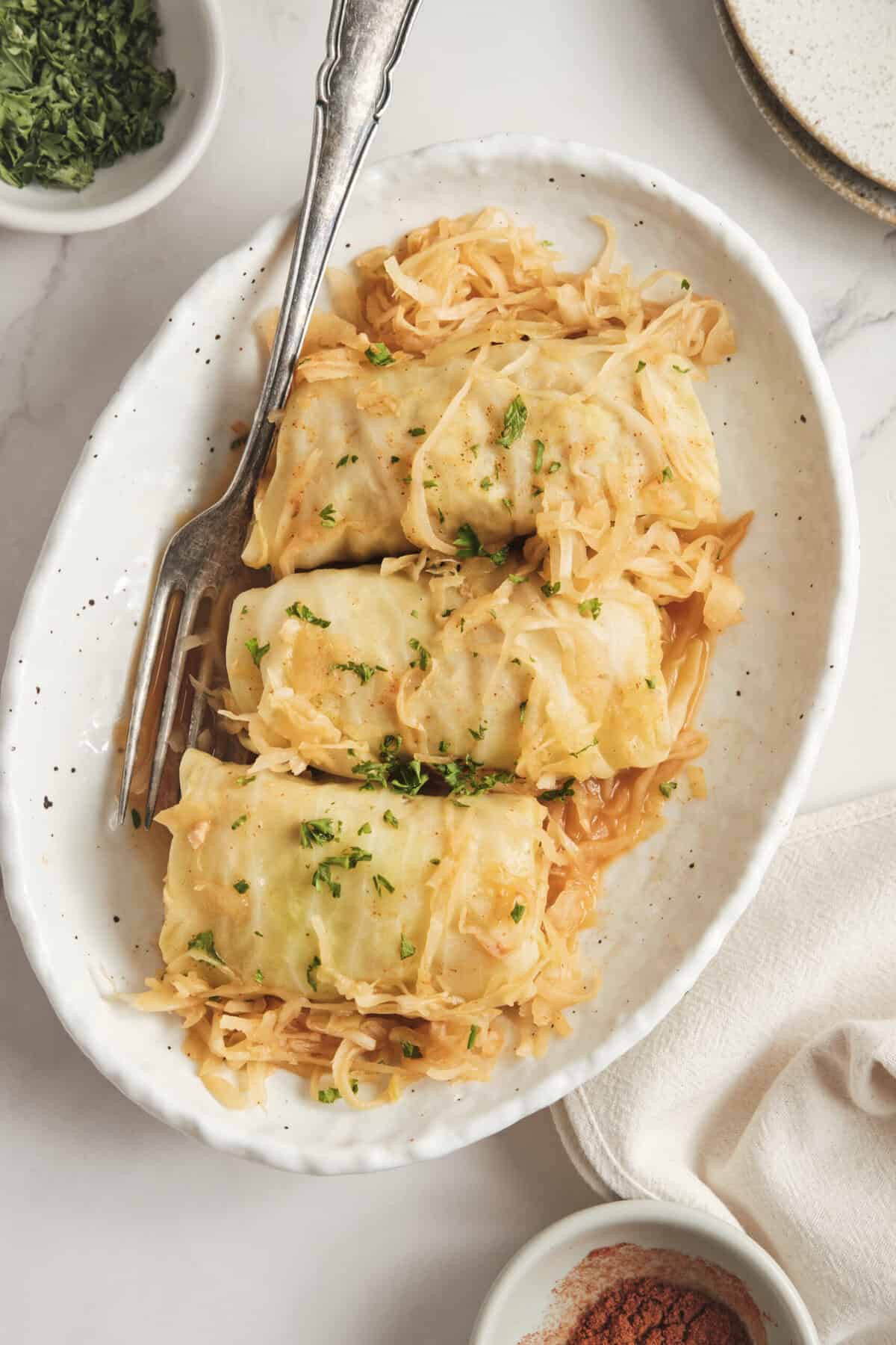 Savoy cabbage rolls stuffed with lean meat and vegetables served with sauerkraut, showcasing healthy, protein-packed recipes for balanced meal planning.