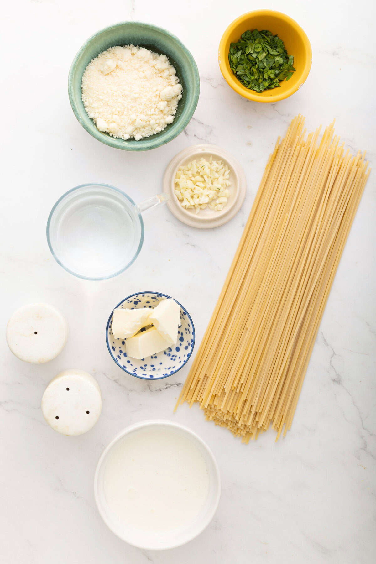 Creamy ricotta cheese, chopped garlic, fresh basil, spaghetti pasta, and other ingredients for healthy, gluten-free Italian pasta recipe. Perfect for quick and nutritious meals.