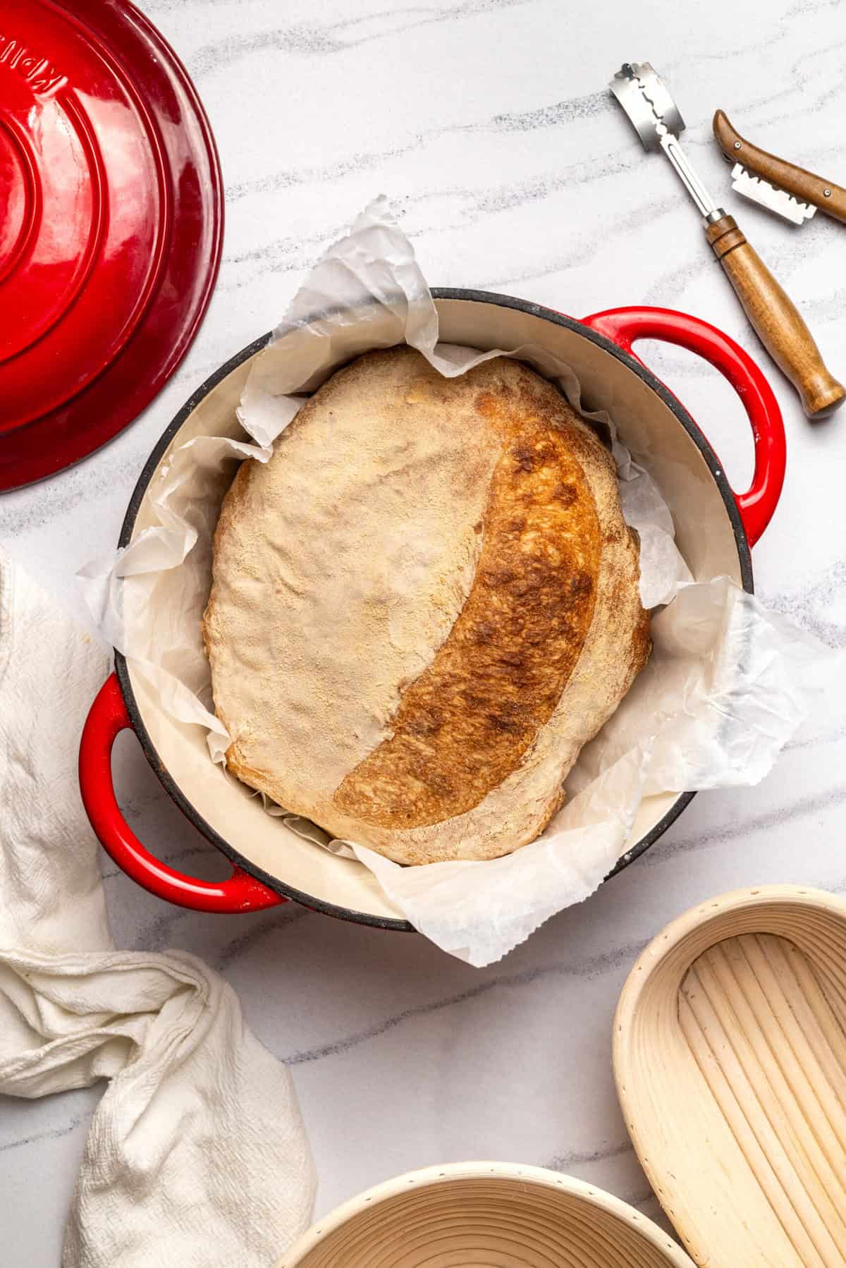 Soft, freshly baked sourdough bread rising in a red Le Creuset Dutch oven, ready for a healthy and delicious meal. Perfect for bread lovers and those focused on nutritious, homemade baking.