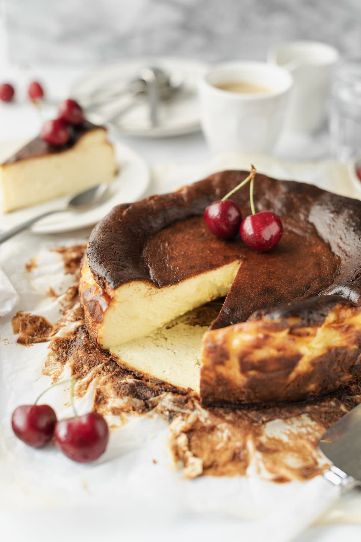 Creamy baked cheesecake with cherries, gluten-free dessert, and chocolate topping on parchment paper. Perfect for healthy dessert recipes and cheesecake lovers.