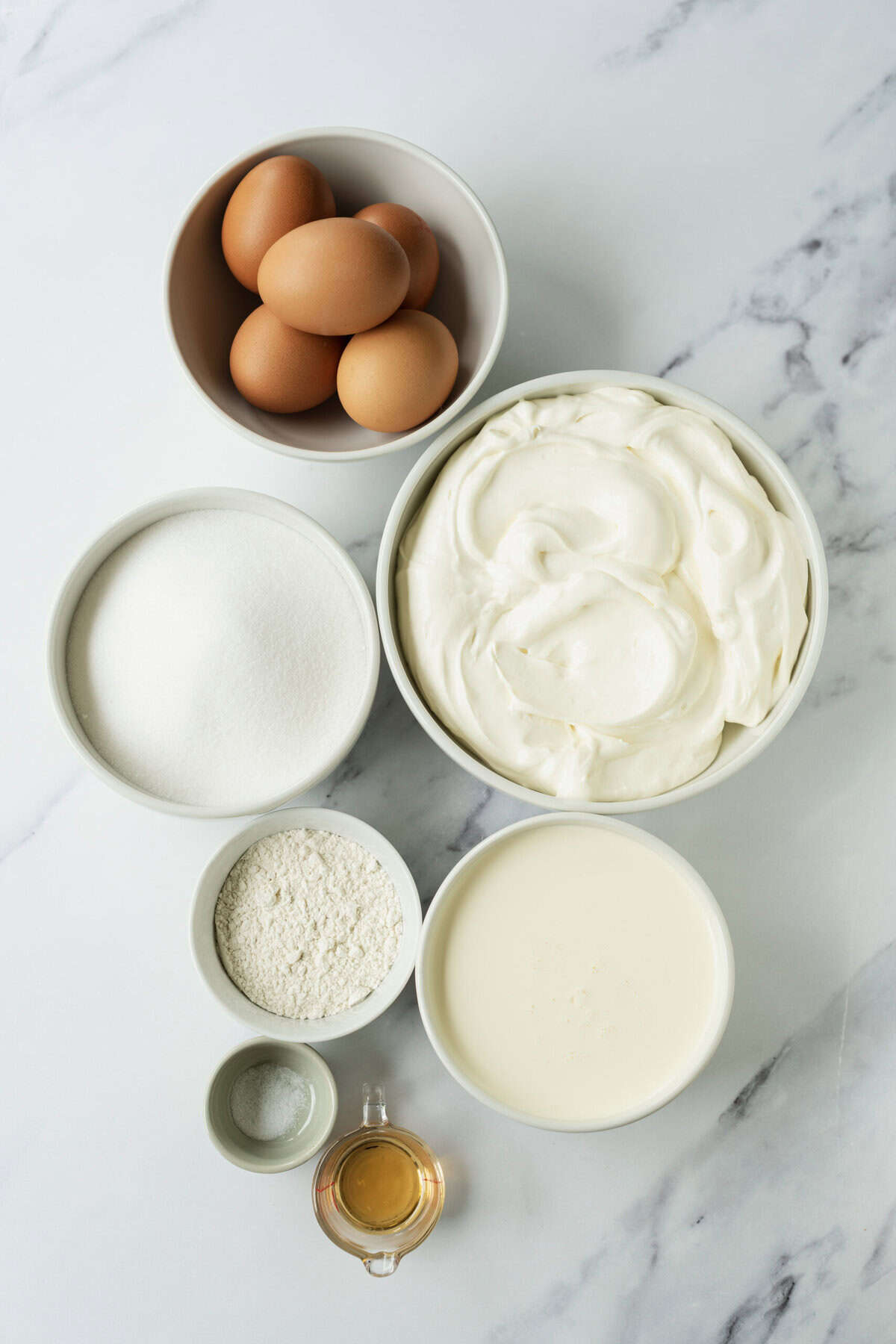 Cream cheese, eggs, flour, sugar, milk, vanilla extract, and butter ingredients for healthy baking recipes, focusing on nutritious breakfast options and protein-rich snacks.