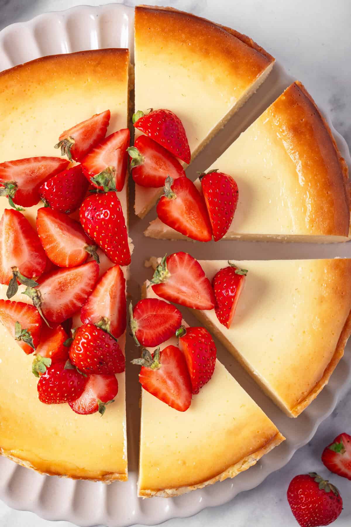 Rich and creamy cheesecake topped with fresh sliced strawberries, perfect for healthy dessert recipes and indulgent treats. Delicious strawberry cheesecake recipe for every occasion.
