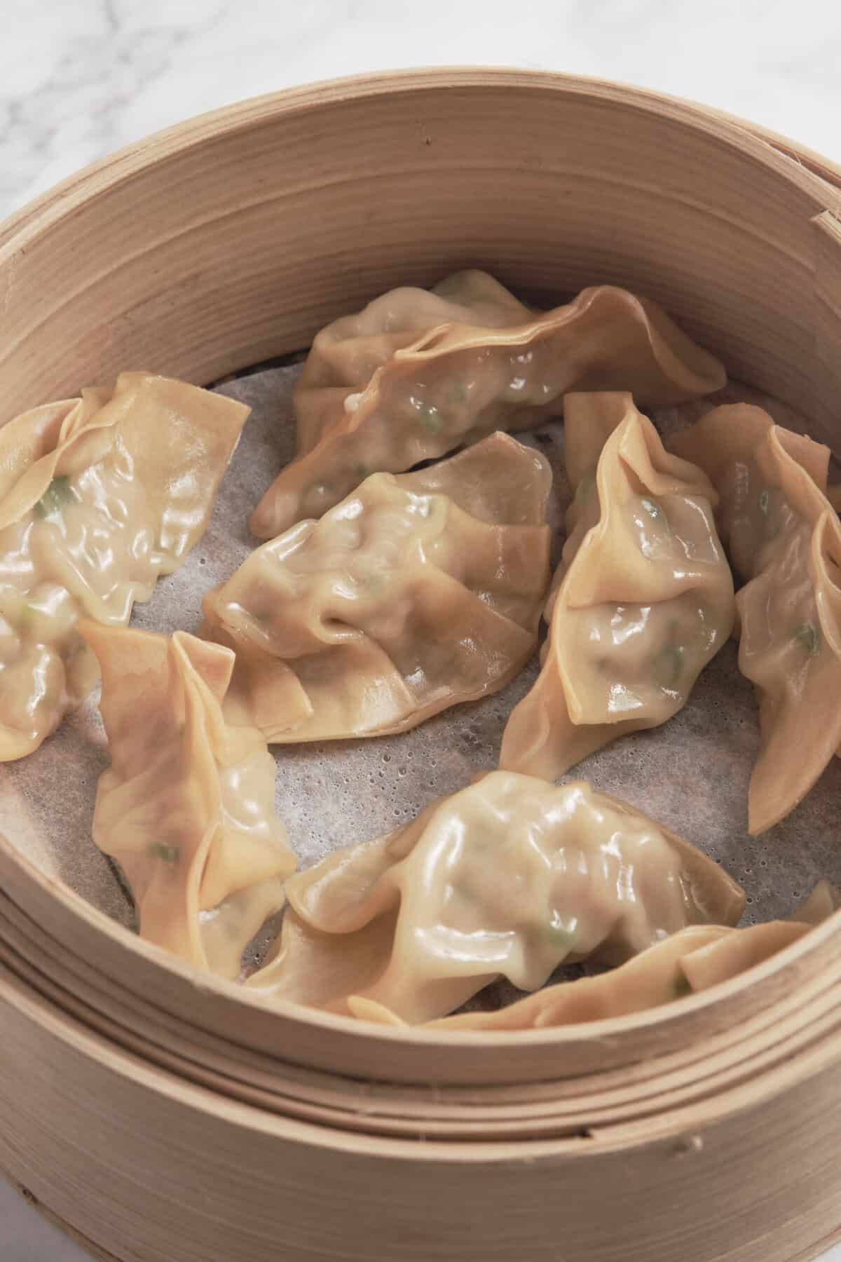 Steamed chicken dumplings in bamboo steamer, healthy Asian-inspired dish, perfect for nutritious meals, gluten-free, high protein, low-calorie, easy to prepare, delicious comfort food, food recipe, food faith fitness.