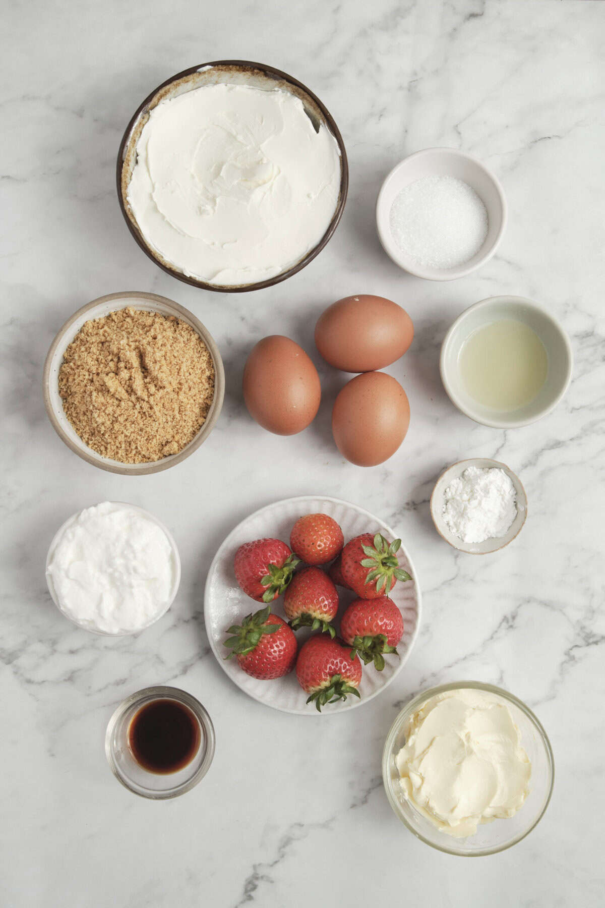 Cream cheese, eggs, strawberries, vanilla, granulated sugar, flour, sour cream, brown sugar, and caramel sauce for healthy strawberry shortcake recipe.