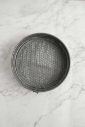 Greased springform pan for strawberry cheesecake.