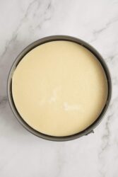 Fluffy cheesecake batter in a springform pan ready for baking, perfect for healthy dessert recipes from Food Faith Fitness.