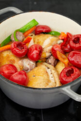 Chicken Scarpariello with sausage and pickled cherry peppers in a pot.