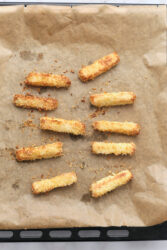 Golden brown halloumi fries on a baking sheet.
