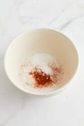 Mixing sugar, salt, and chili powder for homemade honey-roasted peanuts.