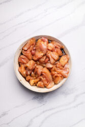 Marinating chicken pieces for Karaage in a bowl.
