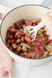 Diced rhubarb simmering in a pot for rhubarb jam.