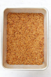 Baked pretzel crust for strawberry pretzel salad in a rectangular baking dish.