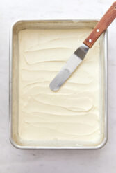 Strawberry pretzel salad creamy filling spread in a rectangular pan.