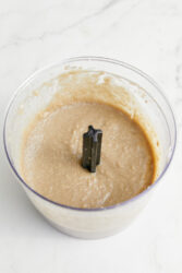 Creamy sunflower seed butter blending in a food processor.