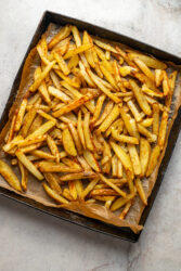 Golden baked cheeseburger fries on a sheet pan.