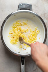 Saut&eacute;ing diced yellow onion for cheeseburger fries.