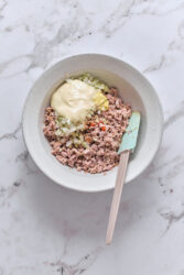Deviled ham ingredients in a bowl, ready to be stirred.