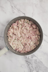 Mixing diced ham and fresh parsley into a thick paste for ham croquettes.