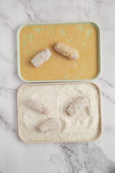 Ham croquettes being breaded in egg wash and breadcrumbs.