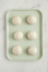 Six smooth dough balls for pork buns.