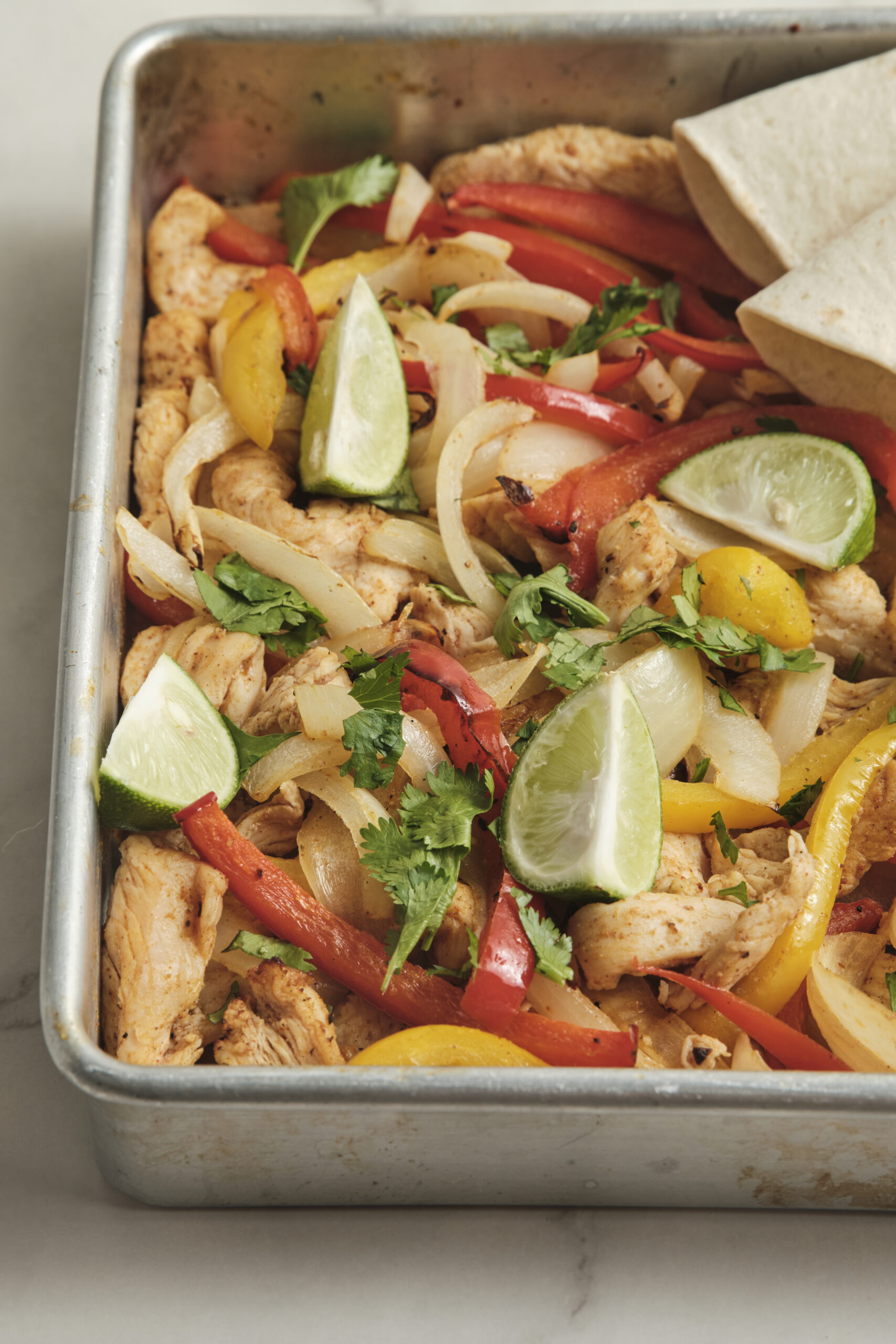 Sheet pan fajitas closeup shot from diagonal.