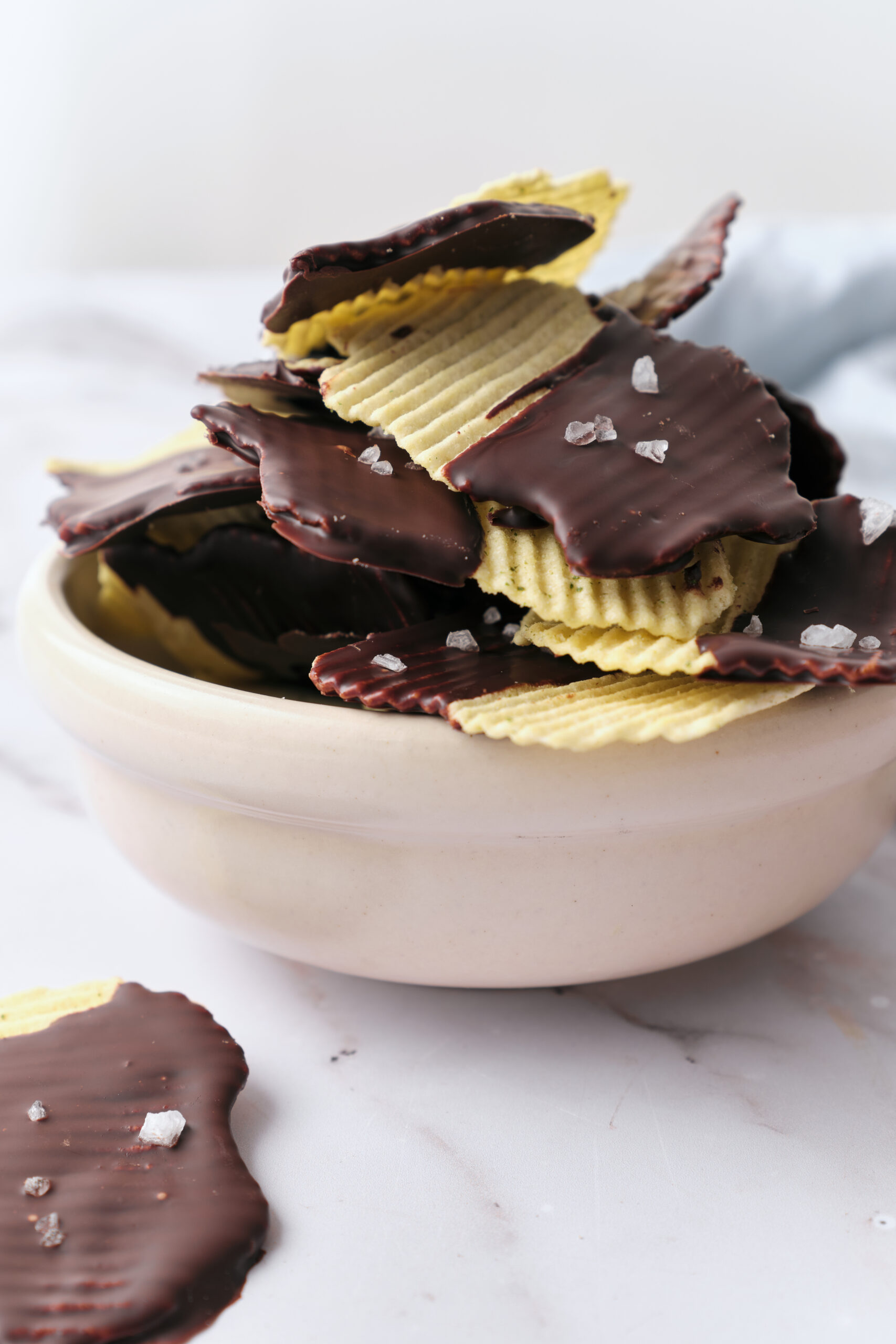 Chocolate Covered Potato Chips in a bowl shot from the side
