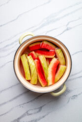 Boiling watermelon rind pieces in a saucepan for watermelon rind pickles.